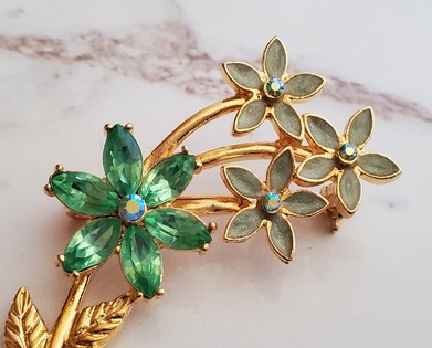 flowers with green enamel, green stones and aurora borealis rhinestones pin detail